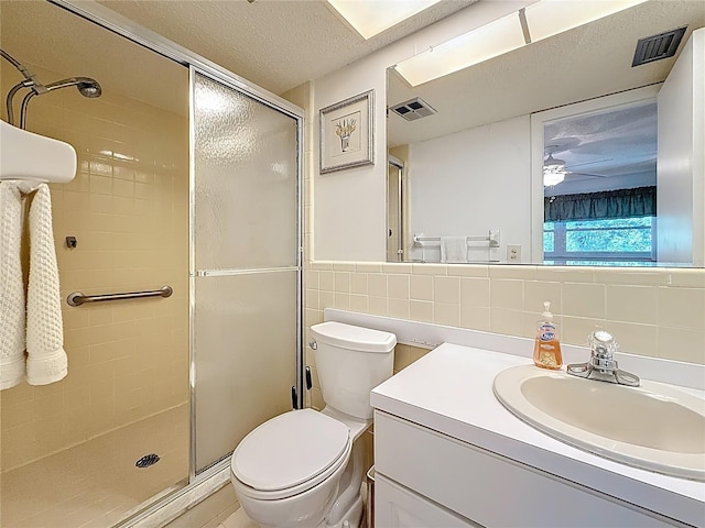 1102 Cara Dr, Largo, FL 33771 - full bathroom featuring a shower stall, vanity, tile walls, a ceiling fan, and a textured ceiling