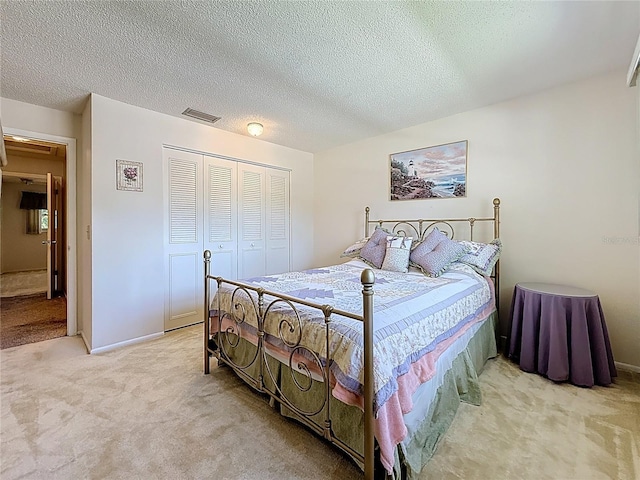 1102 Cara Dr, Largo, FL 33771 - bedroom with light colored carpet, a closet, and a textured ceiling