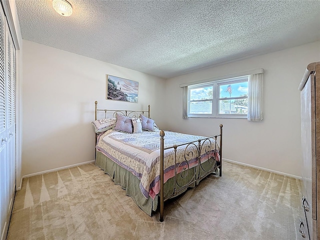 1102 Cara Dr, Largo, FL 33771 - bedroom featuring light carpet, a textured ceiling, and a closet
