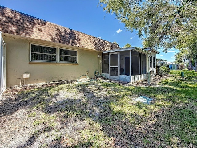 1102 Cara Dr, Largo, FL 33771 - rear view of property with a shingled roof, stucco siding, and a sunroom