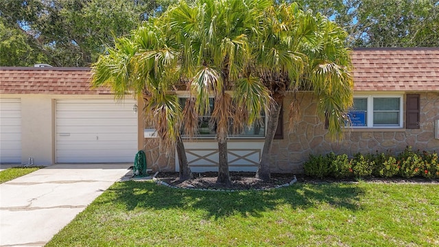 1102 Cara Dr, Largo, FL 33771 - view of front of house featuring stone siding, a shingled roof, a front lawn, and concrete driveway