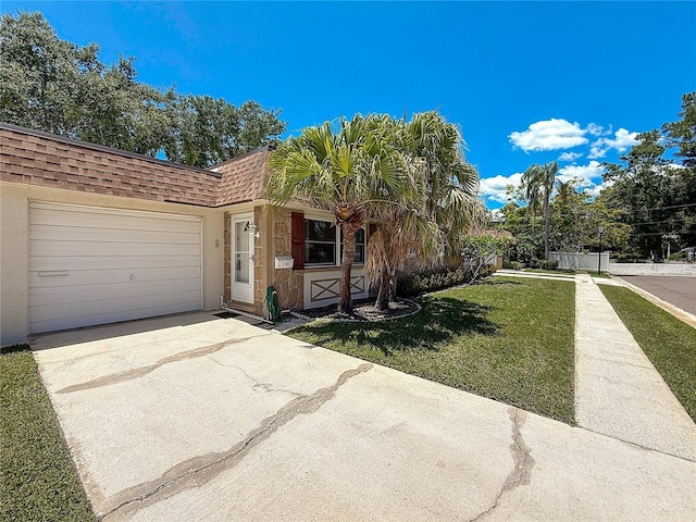 1102 Cara Dr, Largo, FL 33771 - view of front of house with a shingled roof, concrete driveway, mansard roof, a front yard, and an attached garage
