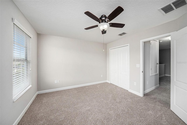 2706 Lantern Hill Ave, Brandon, FL 33511 - unfurnished bedroom featuring carpet flooring, a textured ceiling, a closet, and ceiling fan