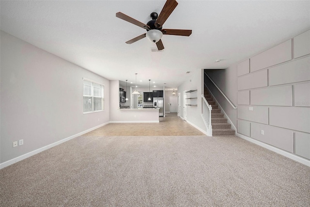 2706 Lantern Hill Ave, Brandon, FL 33511 - unfurnished living room with light colored carpet, stairs, and ceiling fan