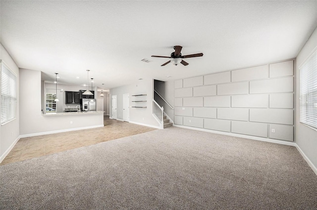 2706 Lantern Hill Ave, Brandon, FL 33511 - unfurnished living room with light carpet, ceiling fan, stairway, and healthy amount of natural light