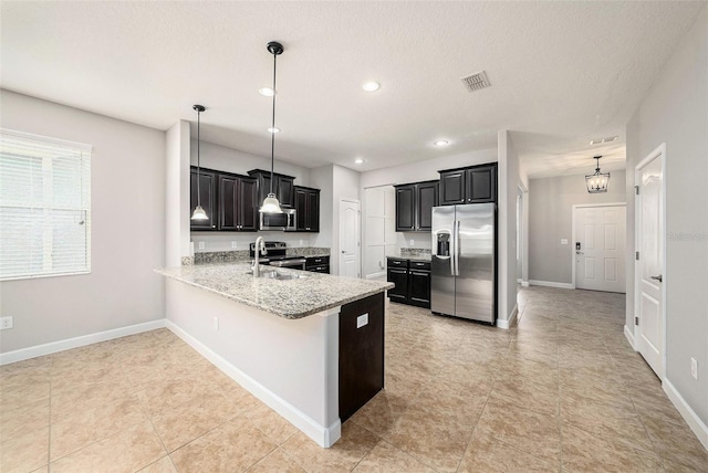 2706 Lantern Hill Ave, Brandon, FL 33511 - kitchen featuring appliances with stainless steel finishes, a peninsula, dark cabinetry, light stone countertops, and recessed lighting