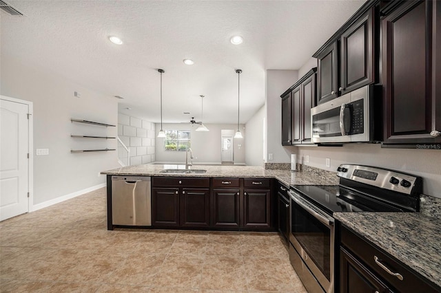 2706 Lantern Hill Ave, Brandon, FL 33511 - kitchen featuring stainless steel appliances, a peninsula, stone counters, decorative light fixtures, and dark brown cabinets