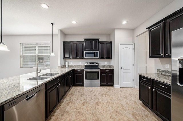 2706 Lantern Hill Ave, Brandon, FL 33511 - kitchen with stainless steel appliances, light stone counters, decorative light fixtures, recessed lighting, and dark cabinetry
