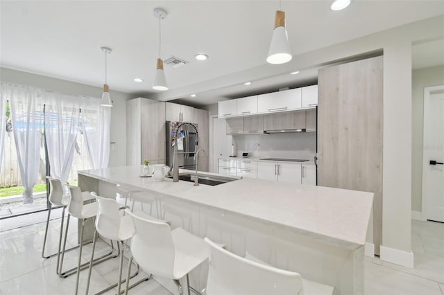15722 Gardenside Ln, Tampa, FL 33624 - kitchen with smart refrigerator, modern cabinets, black electric stovetop, white cabinets, and recessed lighting