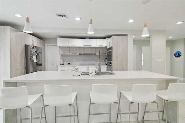 15722 Gardenside Ln, Tampa, FL 33624 - kitchen featuring smart refrigerator, modern cabinets, light countertops, a breakfast bar area, and recessed lighting
