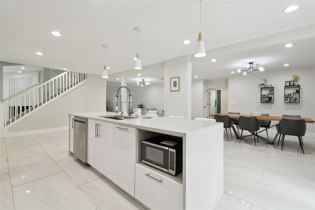 15722 Gardenside Ln, Tampa, FL 33624 - kitchen with appliances with stainless steel finishes, modern cabinets, decorative light fixtures, light countertops, and recessed lighting