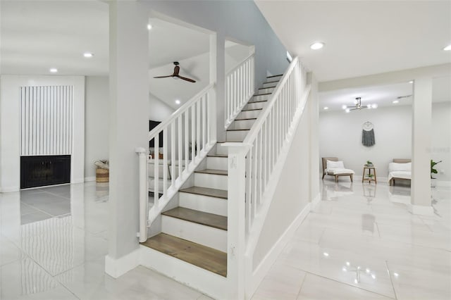 15722 Gardenside Ln, Tampa, FL 33624 - staircase featuring recessed lighting, a ceiling fan, tile patterned flooring, and a large fireplace