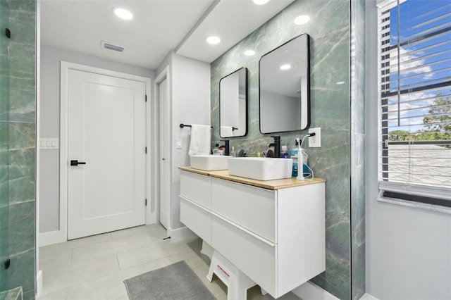 15722 Gardenside Ln, Tampa, FL 33624 - full bath with tile patterned floors, double vanity, tile walls, and recessed lighting