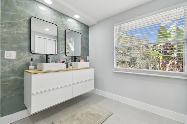15722 Gardenside Ln, Tampa, FL 33624 - bathroom featuring healthy amount of natural light, double vanity, tile patterned floors, and tile walls