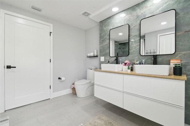 15722 Gardenside Ln, Tampa, FL 33624 - bathroom with tile walls, tile patterned flooring, vanity, and recessed lighting
