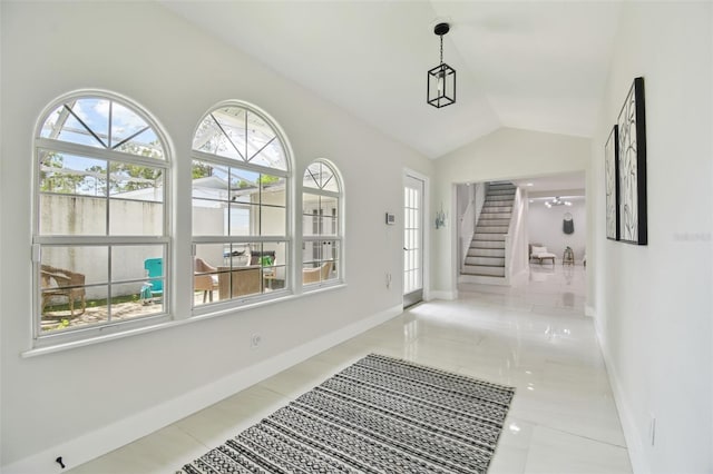 15722 Gardenside Ln, Tampa, FL 33624 - corridor with healthy amount of natural light, stairway, vaulted ceiling, and tile patterned floors