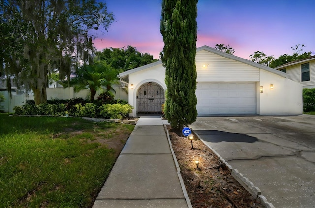 15722 Gardenside Ln, Tampa, FL 33624 - view of front facade with driveway and stucco siding