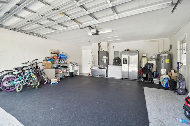 15722 Gardenside Ln, Tampa, FL 33624 - garage featuring water heater, stainless steel refrigerator with ice dispenser, and a garage door opener