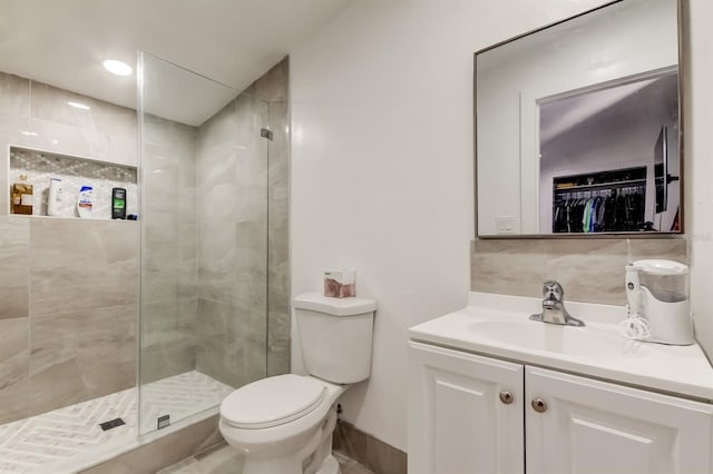 4727 Town N Country Blvd, Tampa, FL 33615 - full bath featuring vanity, a stall shower, a walk in closet, and decorative backsplash