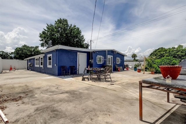 4727 Town N Country Blvd, Tampa, FL 33615 - back of property featuring a patio and stucco siding