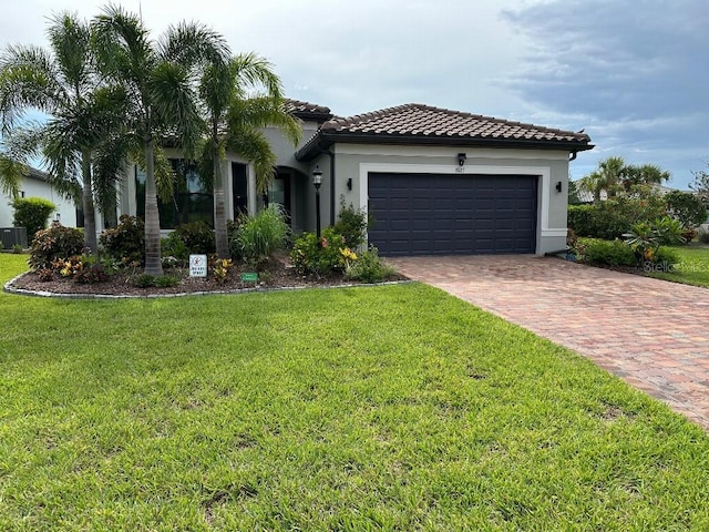 7683 Summerland Cv, Lakewood Ranch, FL 34202 - mediterranean / spanish home with decorative driveway, a garage, a front yard, stucco siding, and a tile roof