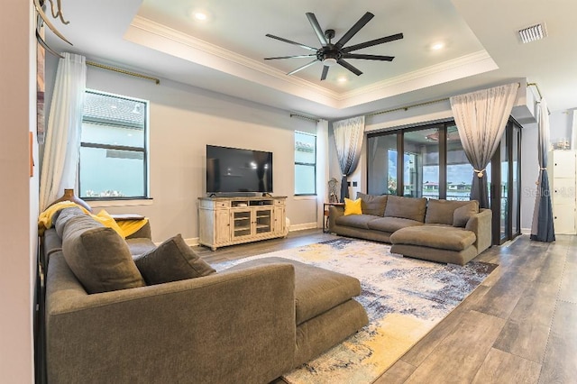 7683 Summerland Cv, Lakewood Ranch, FL 34202 - living area with a raised ceiling, crown molding, wood finished floors, a ceiling fan, and recessed lighting