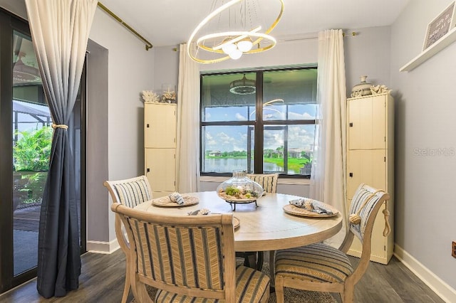 7683 Summerland Cv, Lakewood Ranch, FL 34202 - dining area featuring a chandelier and dark wood-type flooring