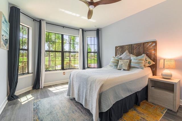 7683 Summerland Cv, Lakewood Ranch, FL 34202 - bedroom with wood finished floors and a ceiling fan