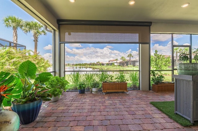 7683 Summerland Cv, Lakewood Ranch, FL 34202 - sunroom with a water view, recessed lighting, and brick floors