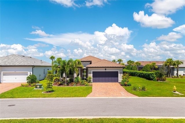 7683 Summerland Cv, Lakewood Ranch, FL 34202 - mediterranean / spanish home with a front yard, a garage, stucco siding, and driveway