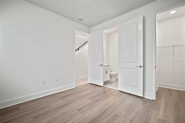 2511 N Grady Ave Unit 43, Tampa, FL 33607 - unfurnished bedroom with wood finished floors, a spacious closet, and a closet