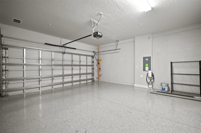 2511 N Grady Ave Unit 43, Tampa, FL 33607 - garage featuring electric panel, concrete block wall, and a garage door opener