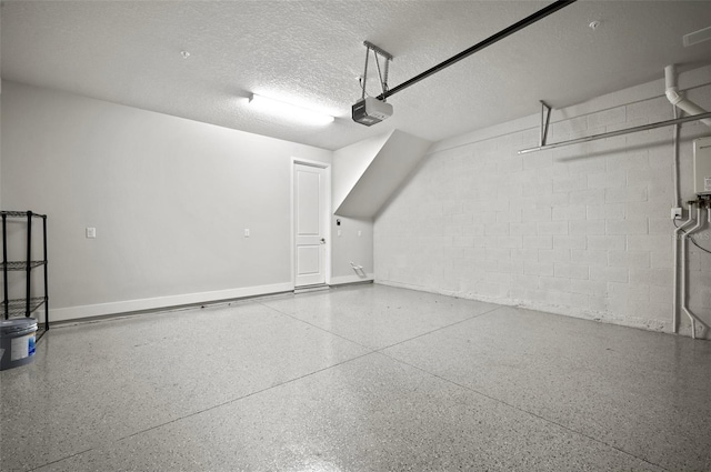 2511 N Grady Ave Unit 43, Tampa, FL 33607 - garage featuring a garage door opener and concrete block wall