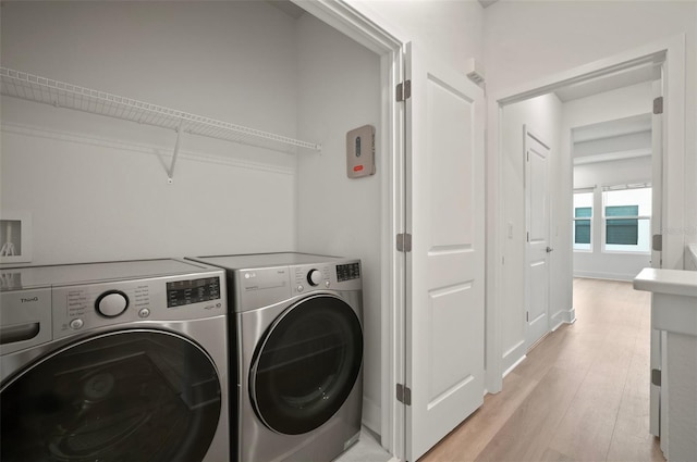 2511 N Grady Ave Unit 43, Tampa, FL 33607 - laundry area featuring independent washer and dryer and light wood-style flooring