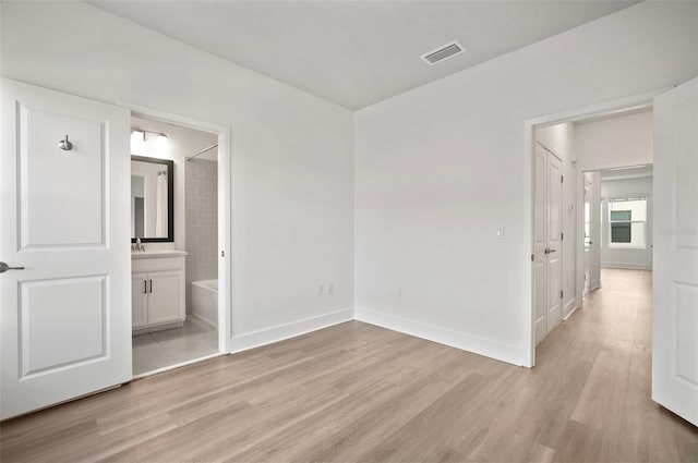 2511 N Grady Ave Unit 43, Tampa, FL 33607 - unfurnished bedroom with light wood-type flooring and ensuite bathroom