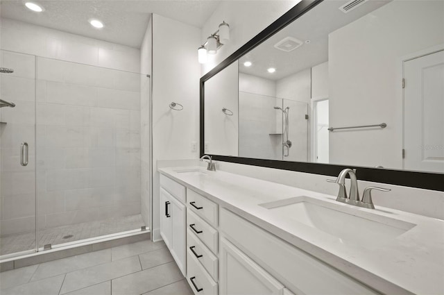 2511 N Grady Ave Unit 43, Tampa, FL 33607 - full bathroom featuring a stall shower, double vanity, tile patterned flooring, and recessed lighting