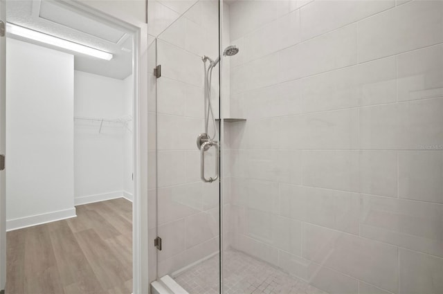 2511 N Grady Ave Unit 43, Tampa, FL 33607 - full bathroom featuring a shower stall, wood finished floors, and a spacious closet