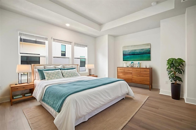 2511 N Grady Ave Unit 43, Tampa, FL 33607 - bedroom with light wood finished floors and a tray ceiling