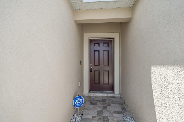 14524 Dunrobin Dr, Wimauma, FL 33598 - view of exterior entry with stucco siding