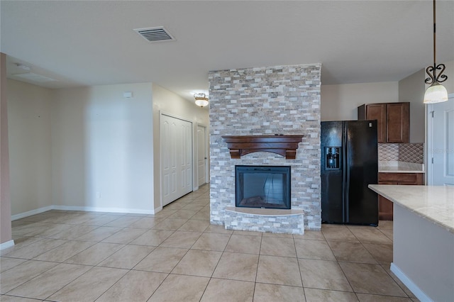 14524 Dunrobin Dr, Wimauma, FL 33598 - unfurnished living room with light tile patterned floors and a stone fireplace