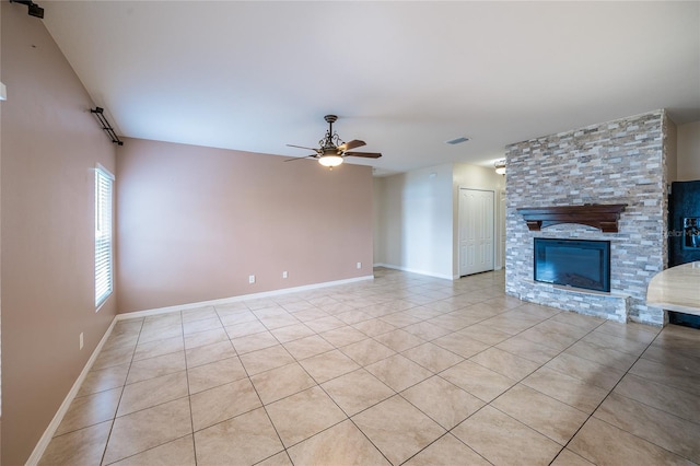 14524 Dunrobin Dr, Wimauma, FL 33598 - unfurnished living room with light tile patterned floors, ceiling fan, and a fireplace