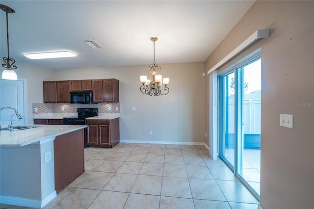 14524 Dunrobin Dr, Wimauma, FL 33598 - kitchen featuring black appliances, a chandelier, tasteful backsplash, and hanging light fixtures
