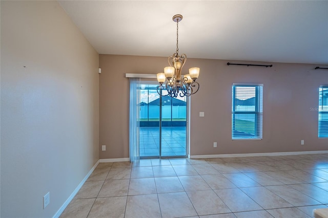 14524 Dunrobin Dr, Wimauma, FL 33598 - unfurnished room with plenty of natural light, light tile patterned floors, and a chandelier