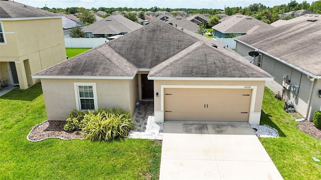 14524 Dunrobin Dr, Wimauma, FL 33598 - single story home featuring roof with shingles, stucco siding, an attached garage, concrete driveway, and a residential view