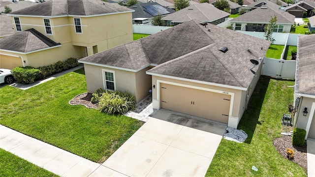 14524 Dunrobin Dr, Wimauma, FL 33598 - view of front of home with a shingled roof, stucco siding, an attached garage, and driveway