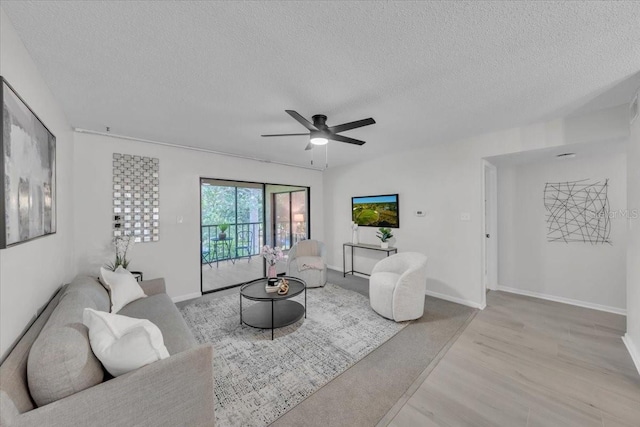 2681 Sabal Springs Cir Unit 204, Clearwater, FL 33761 - living room featuring a textured ceiling, ceiling fan, and wood finished floors