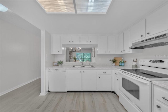 2681 Sabal Springs Cir Unit 204, Clearwater, FL 33761 - kitchen with white appliances, under cabinet range hood, light wood finished floors, and light countertops