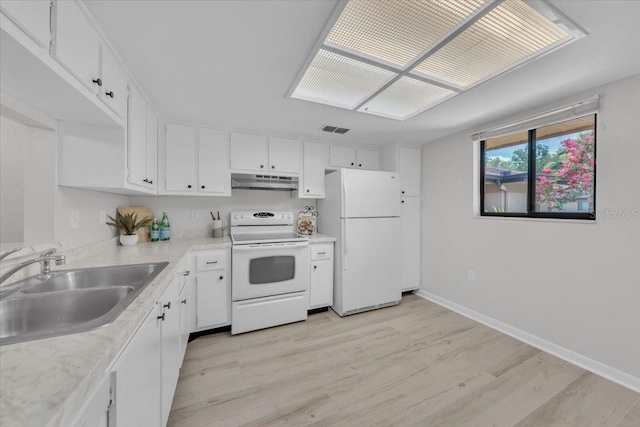 2681 Sabal Springs Cir Unit 204, Clearwater, FL 33761 - kitchen with white appliances, under cabinet range hood, light wood-style floors, white cabinets, and light countertops