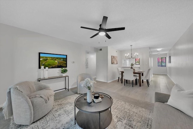 2681 Sabal Springs Cir Unit 204, Clearwater, FL 33761 - living room with a chandelier, ceiling fan, and wood finished floors