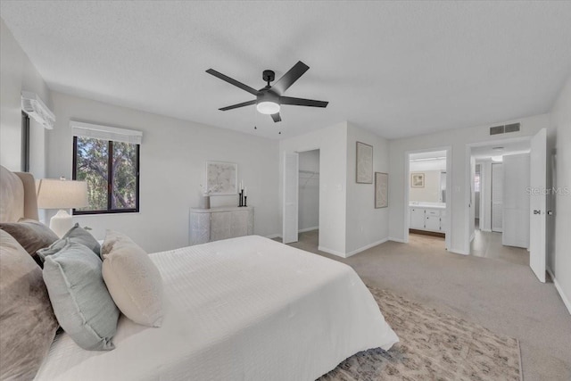 2681 Sabal Springs Cir Unit 204, Clearwater, FL 33761 - bedroom with carpet, a ceiling fan, ensuite bathroom, and a walk in closet